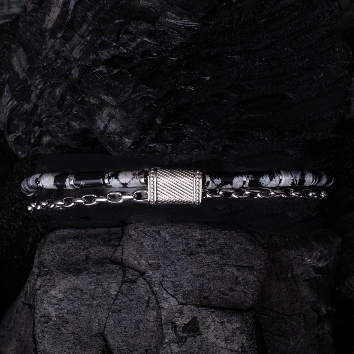 "Supersonic" bracelet in obsidian and silver, featuring a sleek, modern design with intricate details.