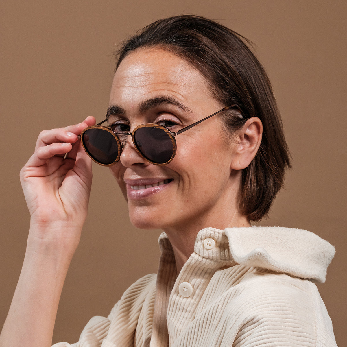 "The Loving" sunglasses featuring zebrawood frames and antique copper accents, exuding a vintage and sophisticated style.