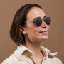 "The Radiant M" sunglasses featuring a walnut and antique silver design, embodying a chic and timeless style.