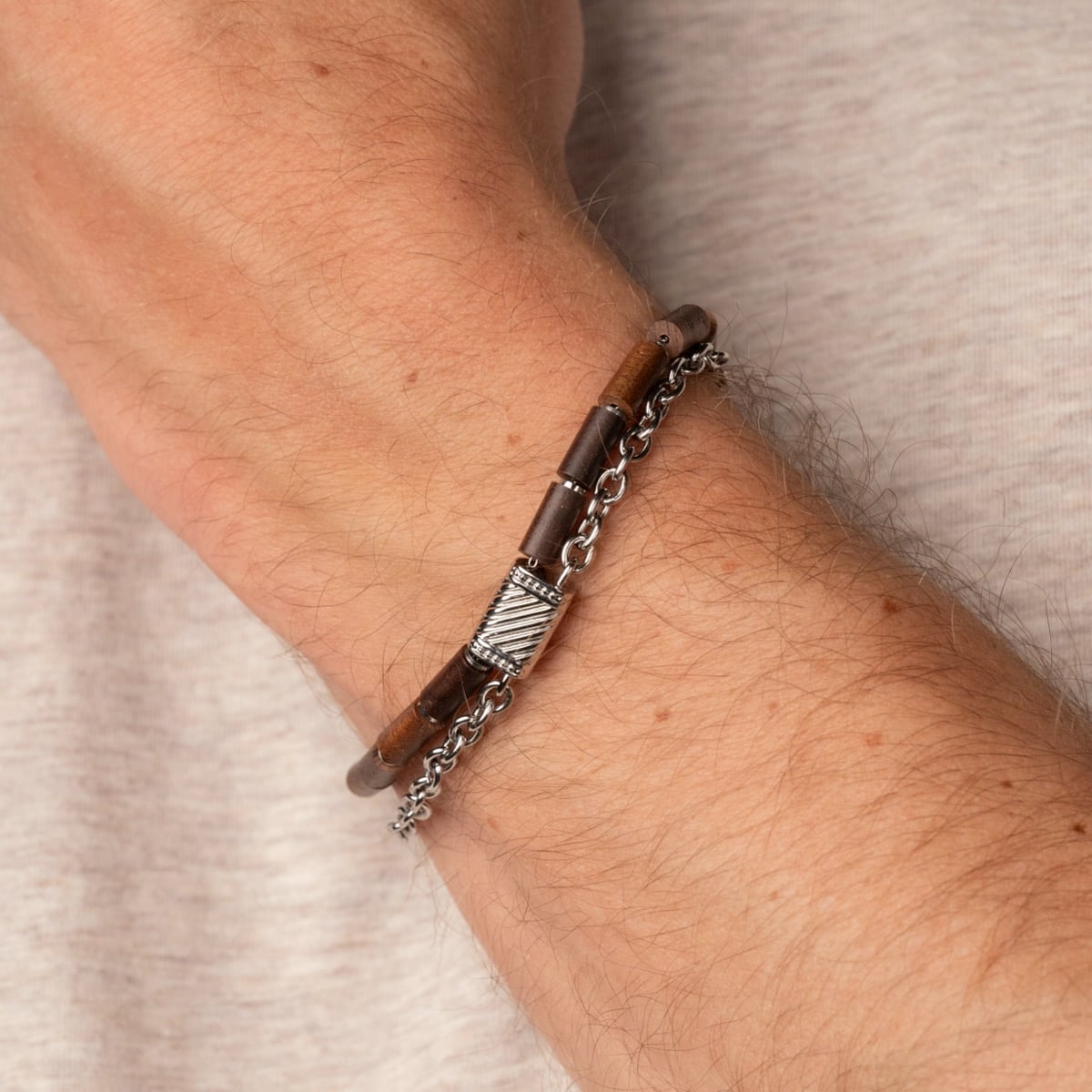 "Supersonic" bracelet, featuring a walnut and silver design, showcasing sleek and stylish craftsmanship.
