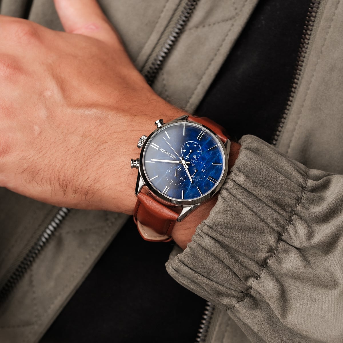 "Naturalist", a stylish watch with a marble dial and silver accents, worn with a brown leather strap for an elegant look.