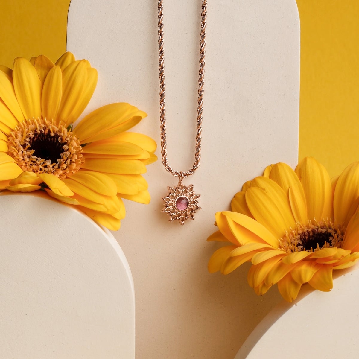 "Suncatcher Necklace" necklace, featuring amethyst and rose gold, elegantly styled against a bright floral background.