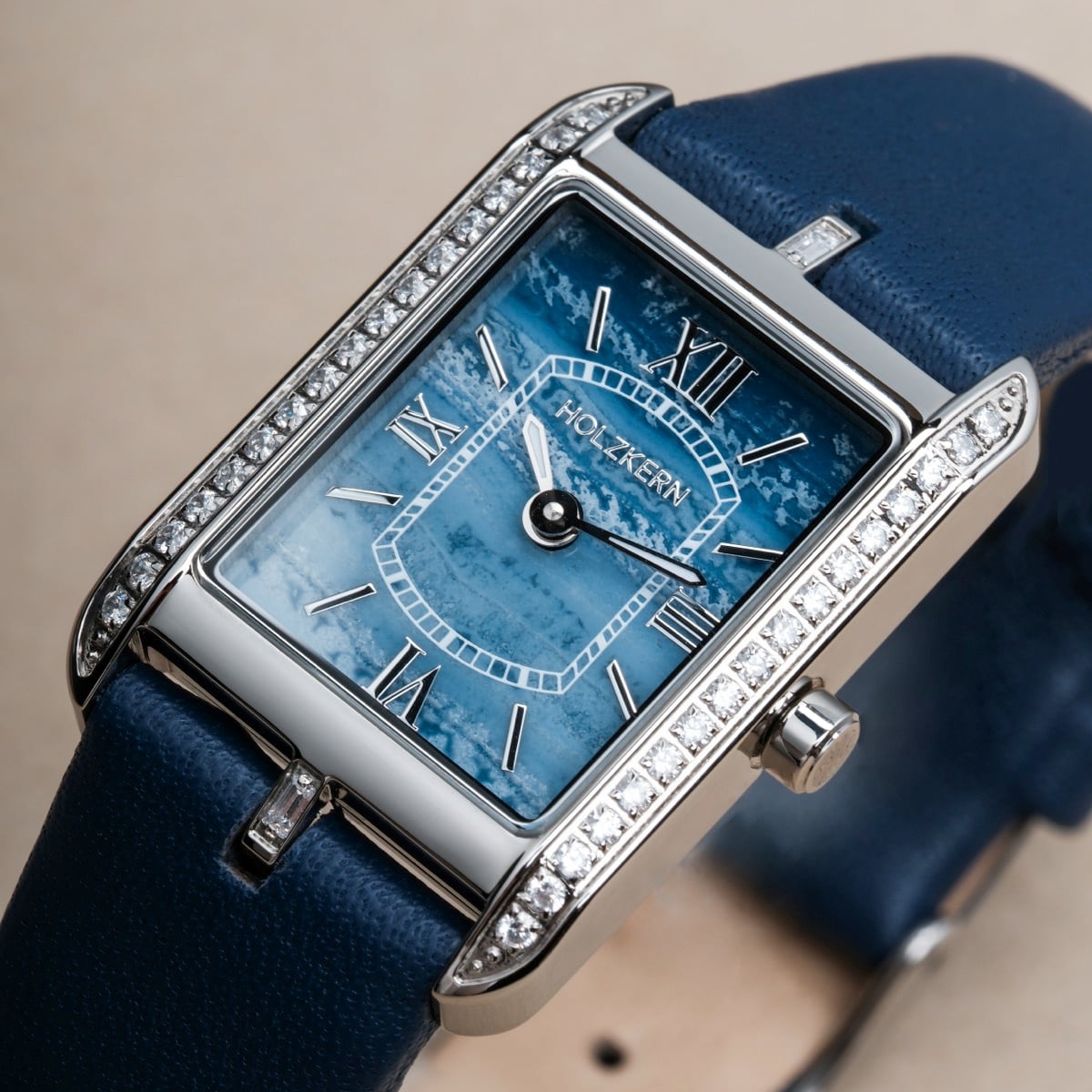 "Memoire", a rectangular watch featuring a blue agate dial and sleek silver-tone accents.