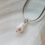 "Summersweet Necklace" necklace featuring a baroque pearl pendant on a sleek silver chain.