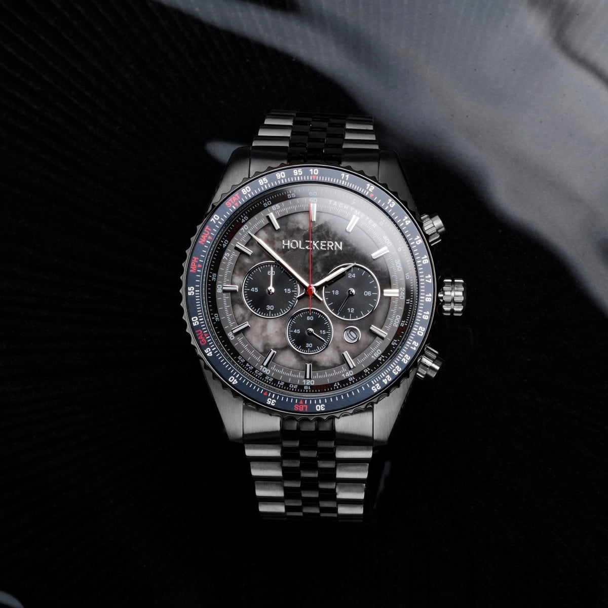 "Openhorizon" watch with a gray marble dial and silver accents on a stainless steel band.