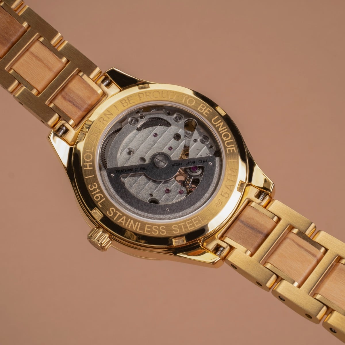 "Kaleidoscopic" wristwatch featuring a nacre and olive design with a stainless steel case and wooden strap.