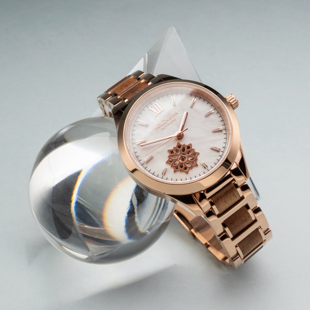 "Kaleidoscopic" watch with a nacre dial and koa wood accents, featuring a kaleidoscopic visual style.