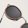 "The Radiant M" sunglasses featuring walnut and antique silver design with a sleek, modern aesthetic.