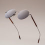 "The Adventurous" sunglasses featuring a sleek design in Walnut and dark gray tones.