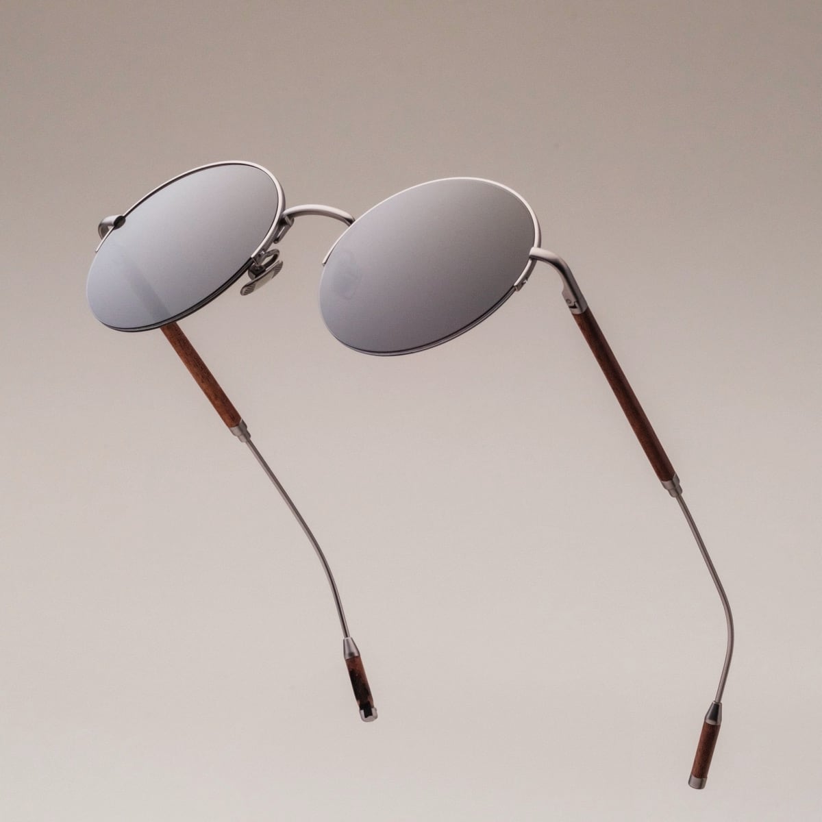 "The Adventurous" sunglasses featuring a sleek design in Walnut and dark gray tones.