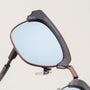 "The Virtuoso" sunglasses featuring a Leadwood and Ash-style frame with a sleek, modern design.
