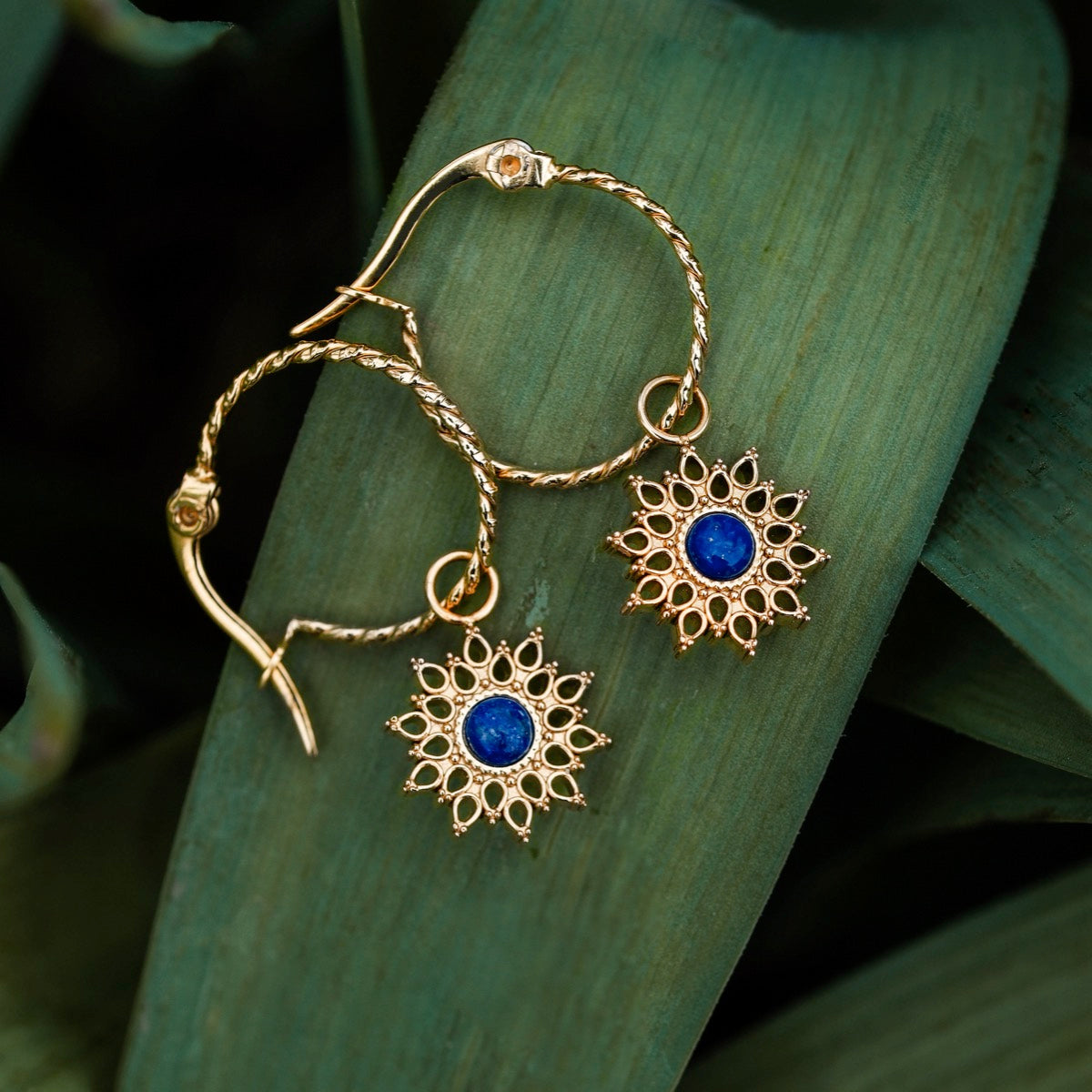 Suncatcher earrings, elegant gold earrings featuring lapis lazuli stones in a sunburst design.