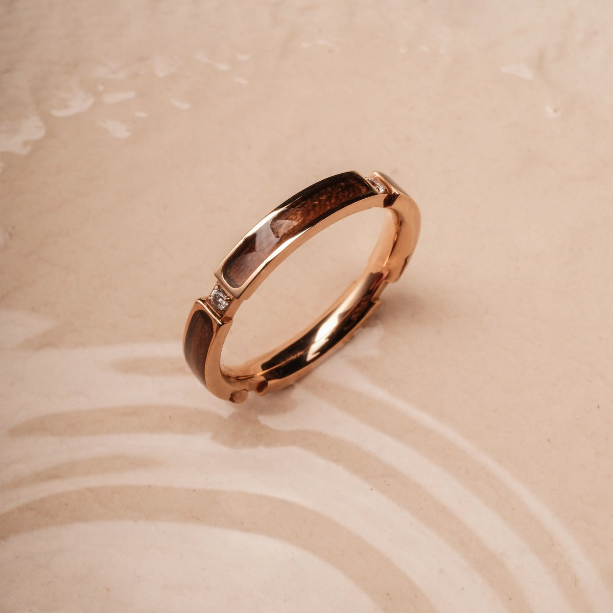 "Campania Ring II" ring featuring a walnut and rose gold design with a refined, elegant style.