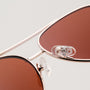 "The Badass II" sunglasses in walnut and matte gold with a sleek, stylish design.