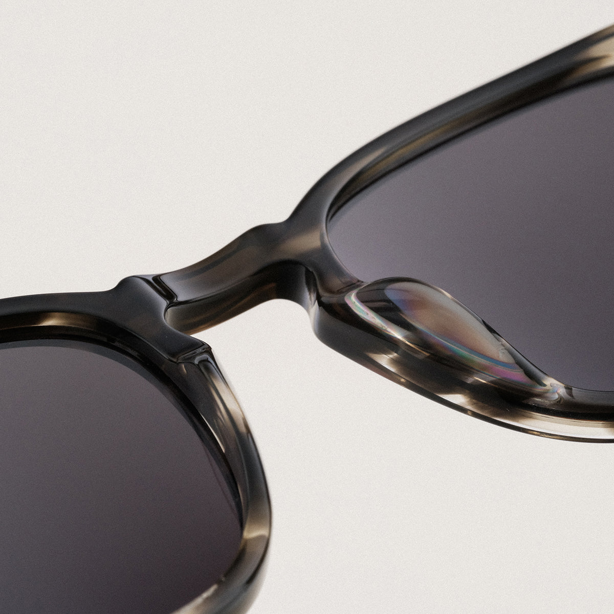 "The Comedian" sunglasses with a Leadwood frame and Khaki Dust lenses, showcasing a sleek and modern design style.