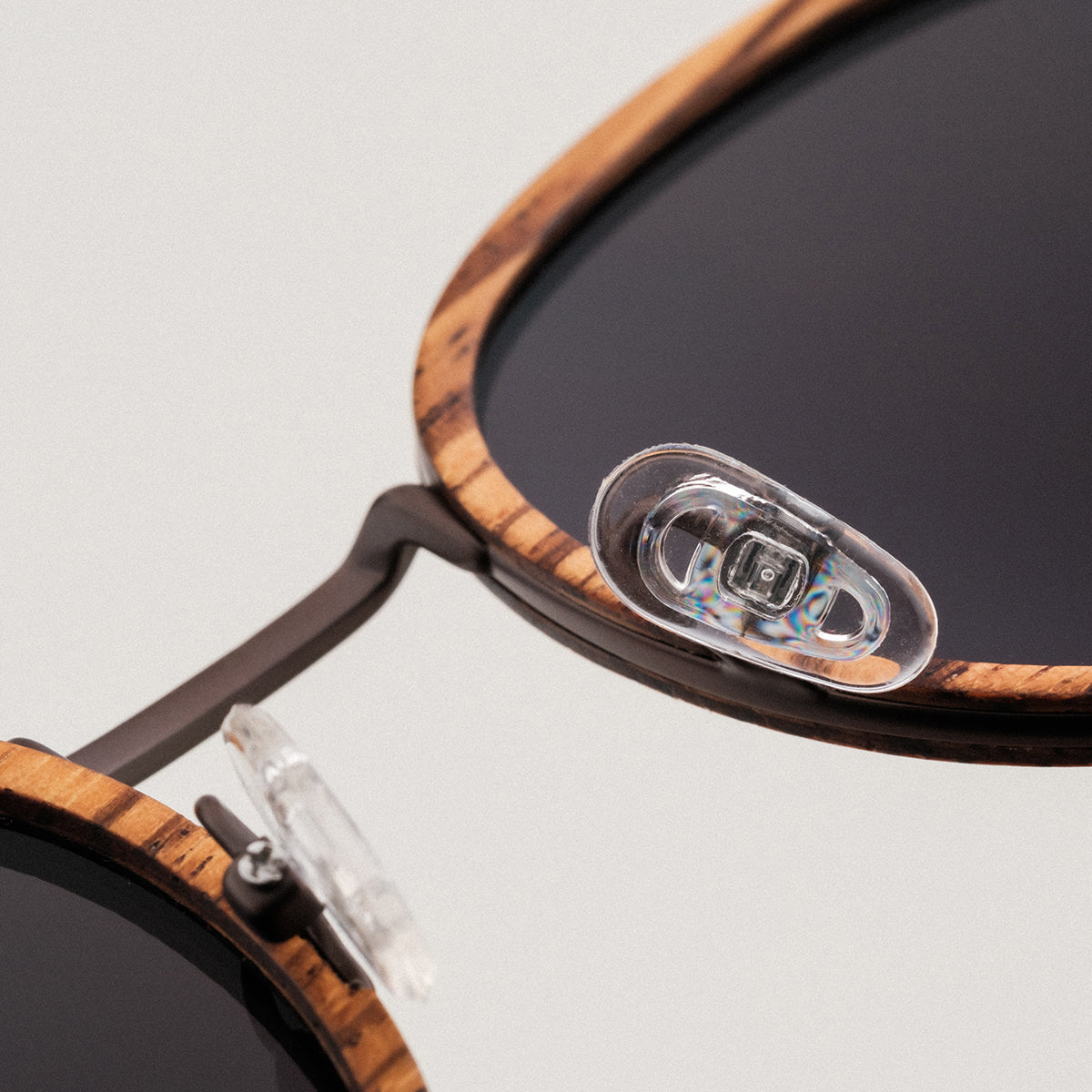 "The Loving" sunglasses, crafted in zebrawood and antique copper, showcasing a stylish and sophisticated design.