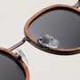 "The Radiant M" sunglasses featuring a walnut frame and antique silver accents.