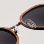 "The Radiant S" sunglasses featuring a sleek design with walnut and copper accents.
