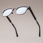 "The Virtuoso" eyeglasses with a sleek, modern design featuring Leadwood and Ash materials.