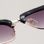 "The Virtuoso" sunglasses with a sleek Leadwood/Black Havana design and modern aesthetic.