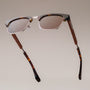 "The Virtuoso" sunglasses featuring a walnut and havana design with sleek style.