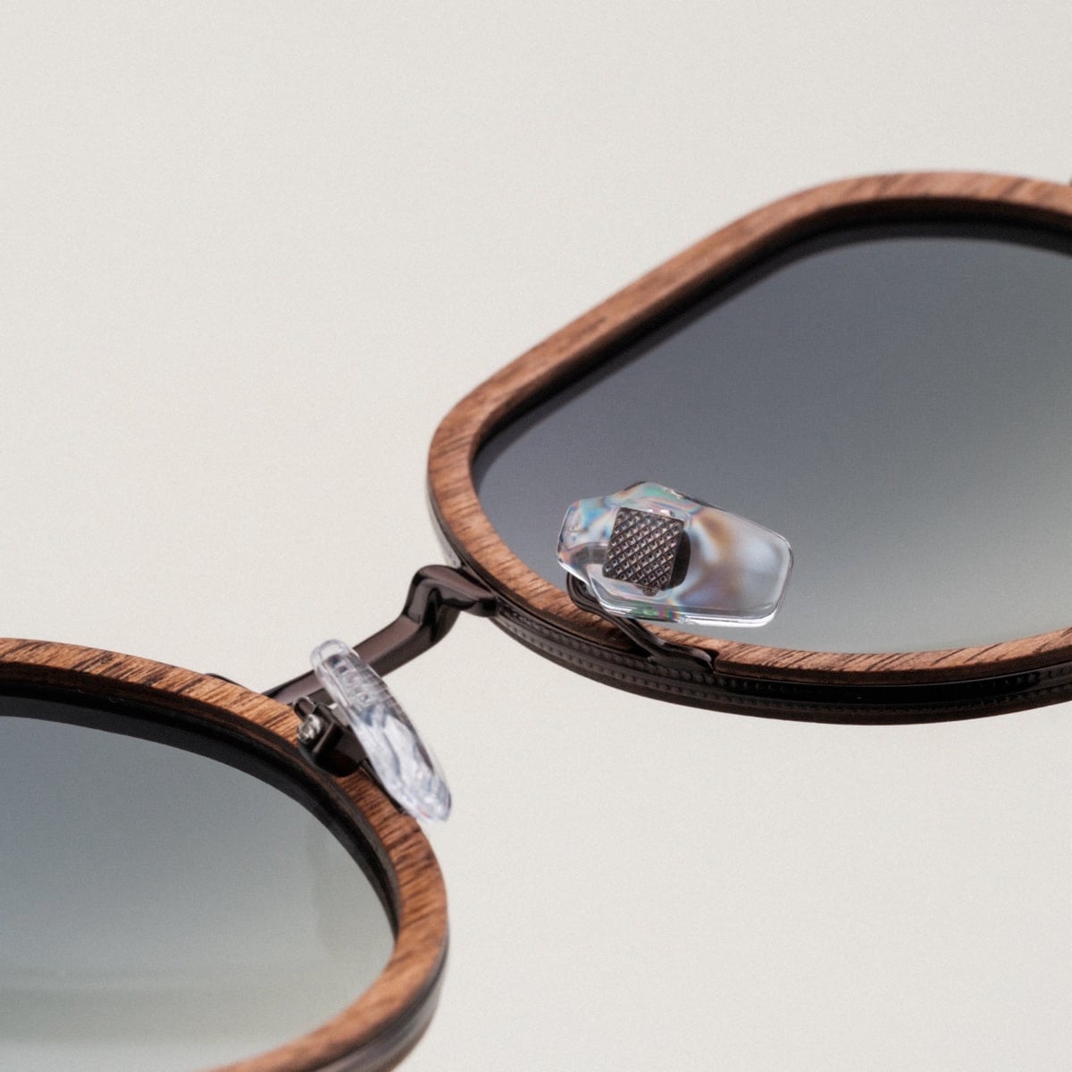 "The Wanderer" sunglasses with walnut frames and bronze accents, featuring a sleek and stylish design.