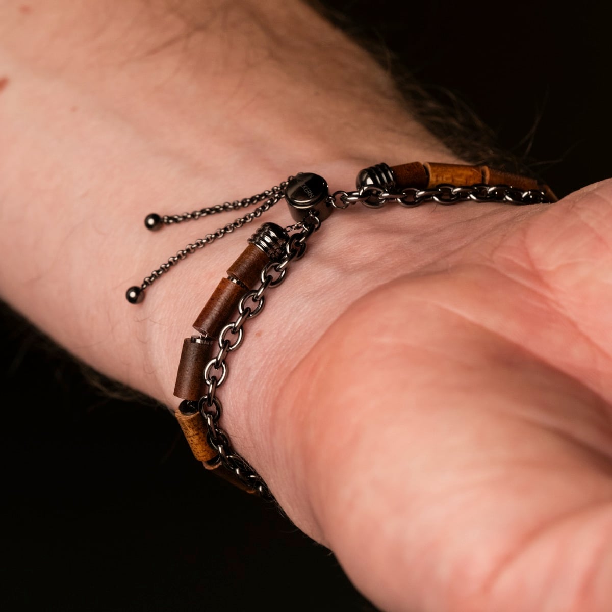 "Supersonic" bracelet featuring a unique blend of koa wood and gray metal elements on a wrist.