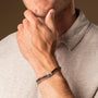 "Supersonic" bracelet featuring a walnut and silver design, showcasing a stylish and modern aesthetic.