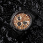 "Genevra watch featuring burl wood and maple, elegant chronograph design in a rich, dark setting."