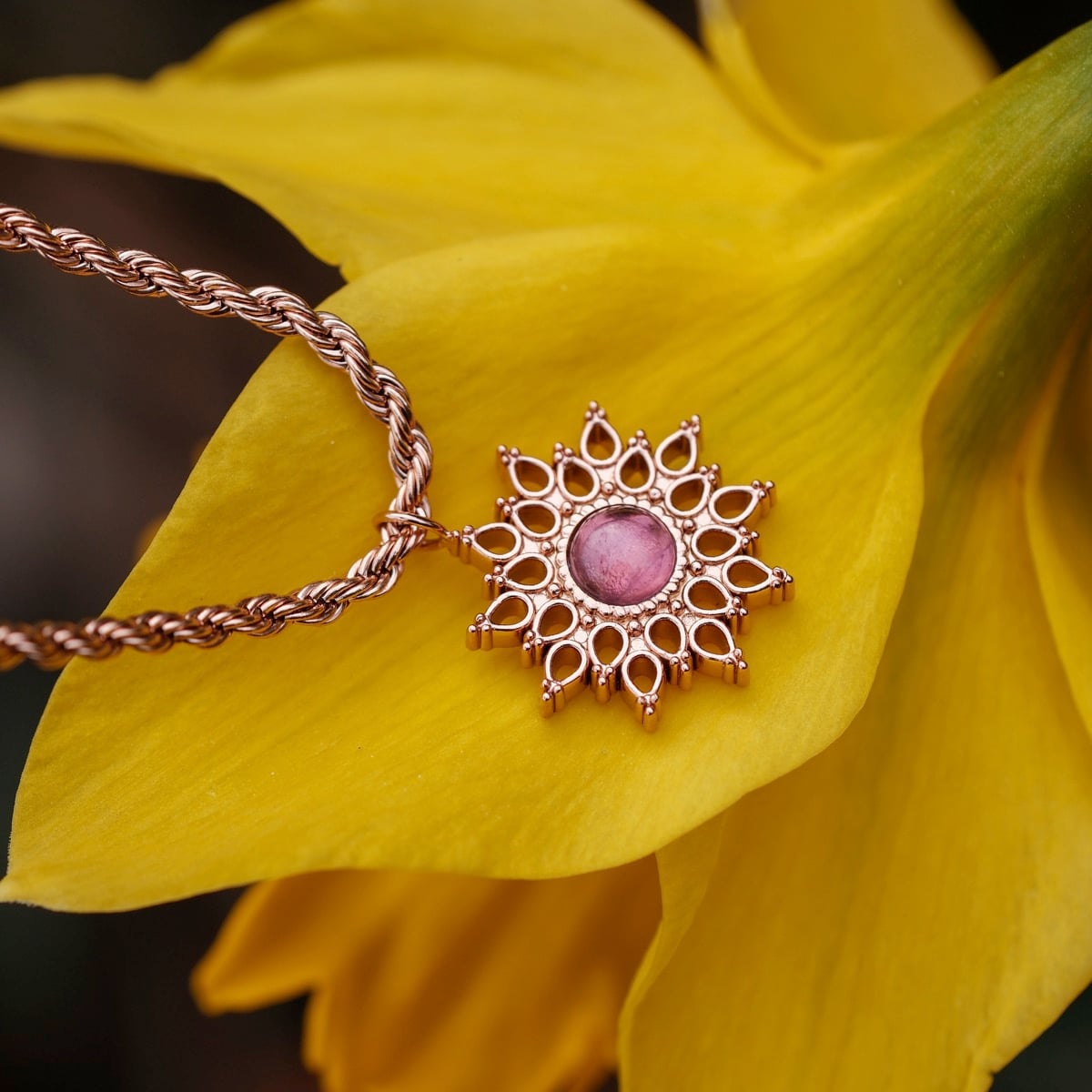 "Suncatcher Necklace": A rose gold suncatcher necklace featuring an amethyst centerpiece with intricate detailing.