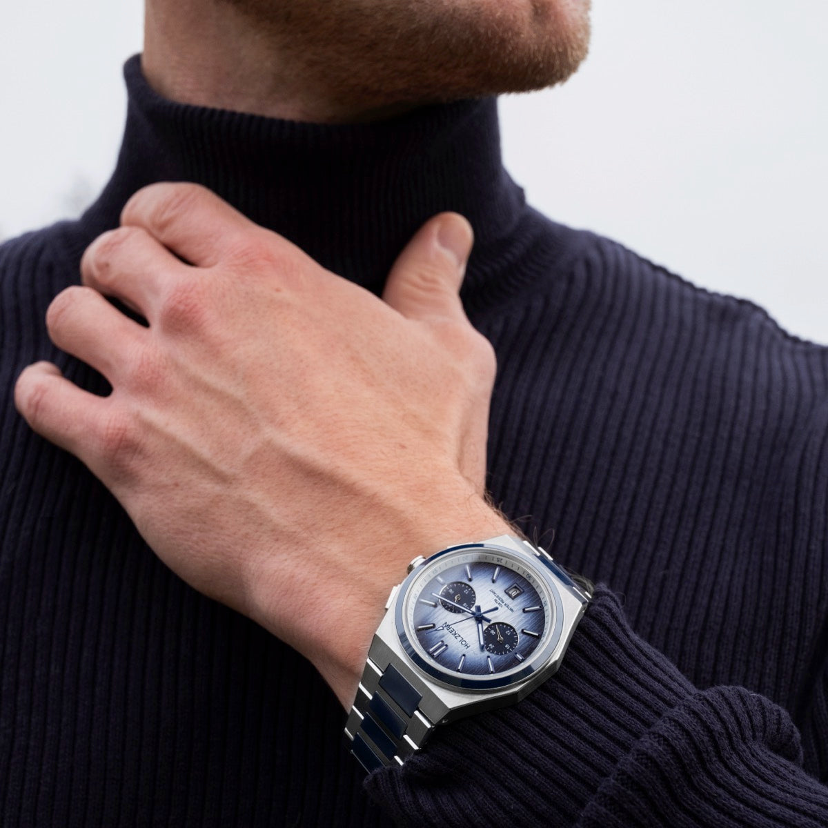 "Oceanswell" watch featuring a ceramic and silver design with a sleek, modern aesthetic on a wrist.