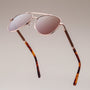"The Badass II" sunglasses featuring a walnut frame and matte gold finish for a sleek, modern look.