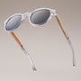 "The Hyped" sunglasses in zebrawood and crystal, featuring a modern and transparent design.