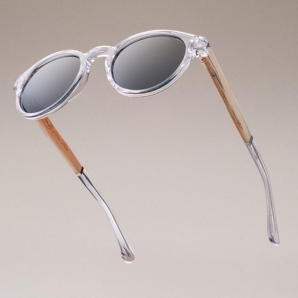 "The Hyped" sunglasses in zebrawood and crystal, featuring a modern and transparent design.