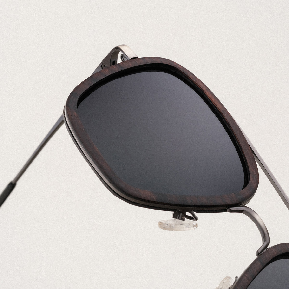 "The Logician" sunglasses featuring a sleek leadwood frame and antique silver accents.