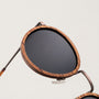"The Loving" sunglasses feature round zebrawood frames and antique copper accents.