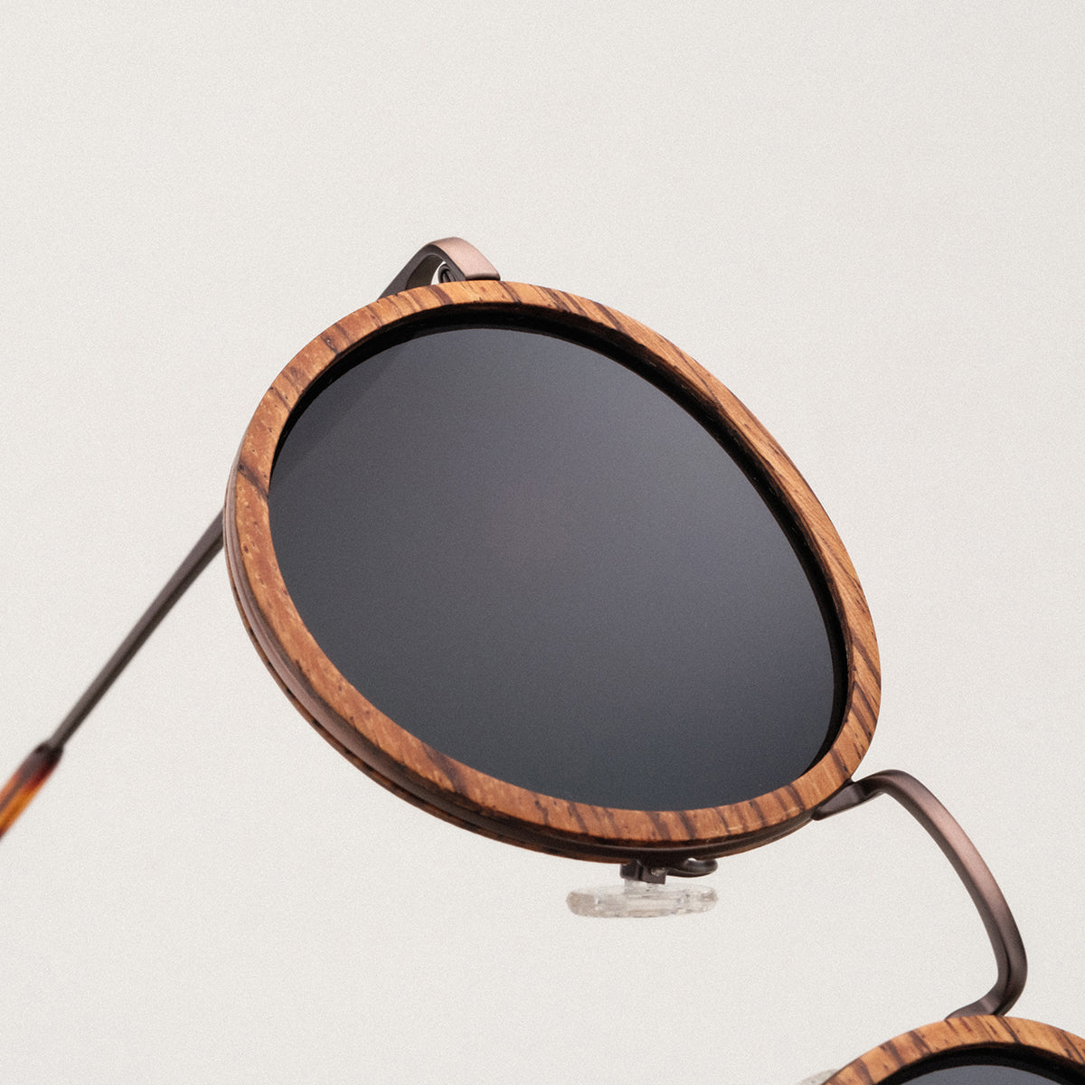 "The Loving" sunglasses feature round zebrawood frames and antique copper accents.