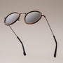 "The Radiant M" sunglasses featuring a walnut frame and antique silver accents with a sleek, modern design.
