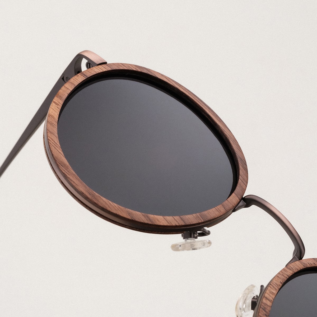 "The Radiant S" sunglasses with walnut and copper frame, featuring a sleek and modern design.