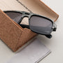 "The Triumphant" sunglasses featuring a sleek maple and slate design in a cork box.