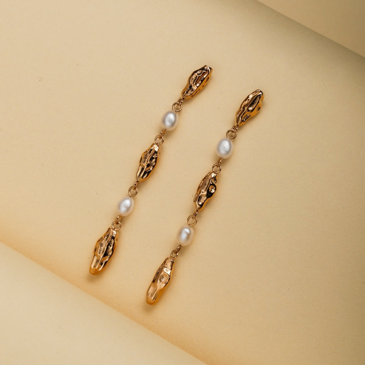 "Summersweet Earrings I": Elegant pearl and gold earrings with a delicate, elongated design.