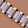 "Kaleidoscopic" bracelet with amethyst and ceramic accents, showcasing a sleek, modern style.