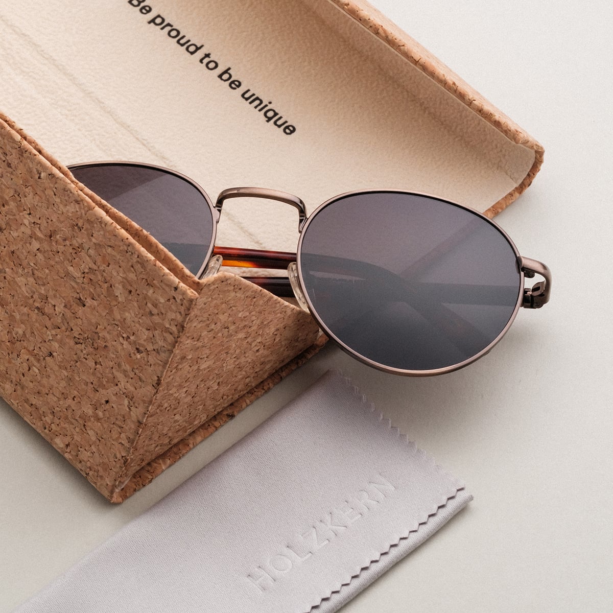 "The Achiever" sunglasses featuring a stylish walnut and copper design in a unique cork case.