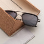 "The Logician" sunglasses feature a stylish blend of leadwood and antique silver accents, offering a unique, elegant look.