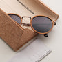 "The Loving" sunglasses feature a stylish zebrawood frame and antique copper accents, presented with a unique cork case.
