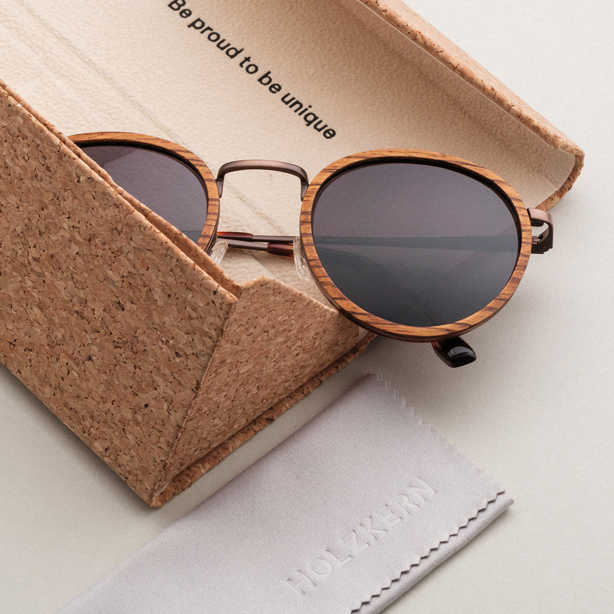 "The Loving" sunglasses feature a stylish zebrawood frame and antique copper accents, presented with a unique cork case.