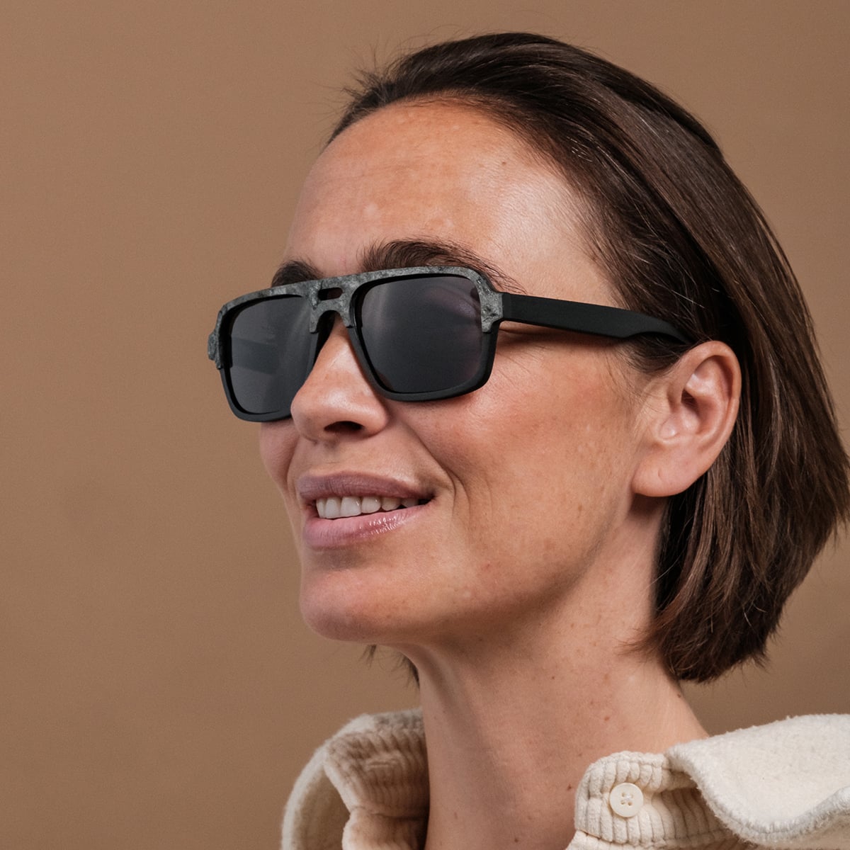 "The Triumphant" sunglasses feature a modern Maple/Slate design with a sleek, stylish frame.
