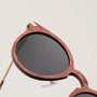 "The Maverick" sunglasses, featuring a Padouk wood frame and copper accents, showcasing a stylish and unique design.