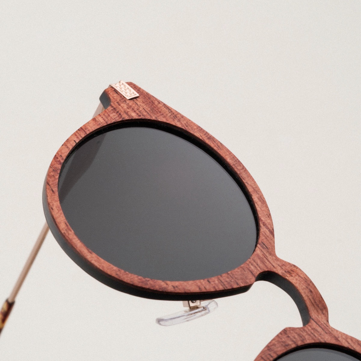 "The Maverick" sunglasses, featuring a Padouk wood frame and copper accents, showcasing a stylish and unique design.
