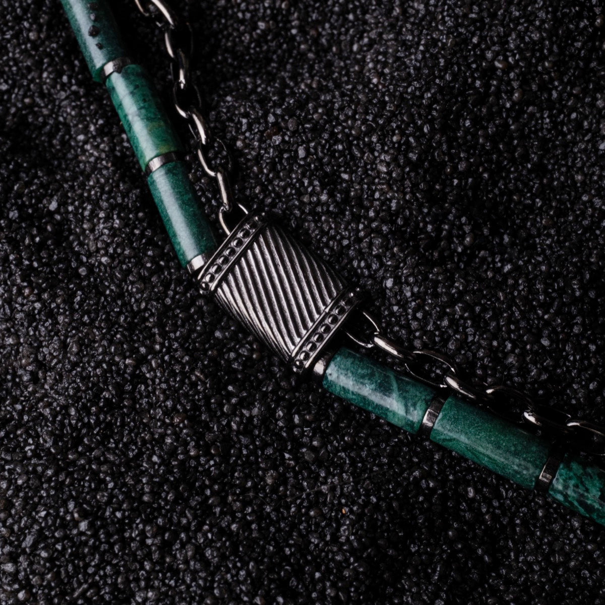 "Supersonic", a stylish aventurine and gray necklace with sleek metal accents.